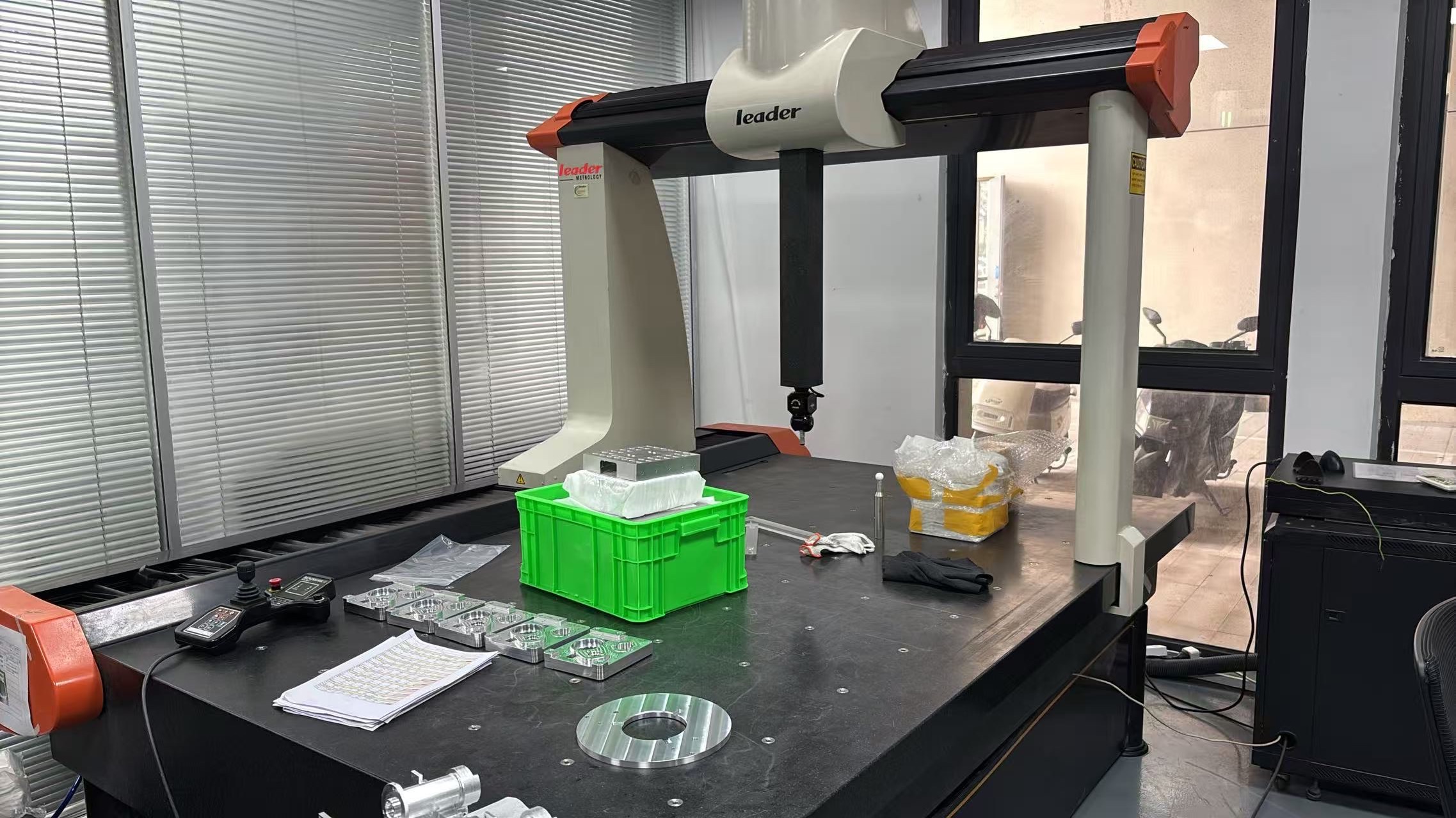 Real CMM inspection equipment with machined parts prepared for measurement